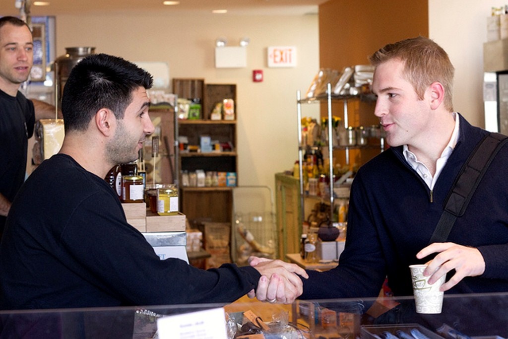 Two people shake hands, good customer service.