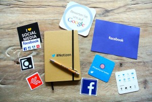 Social media logos and notebook.