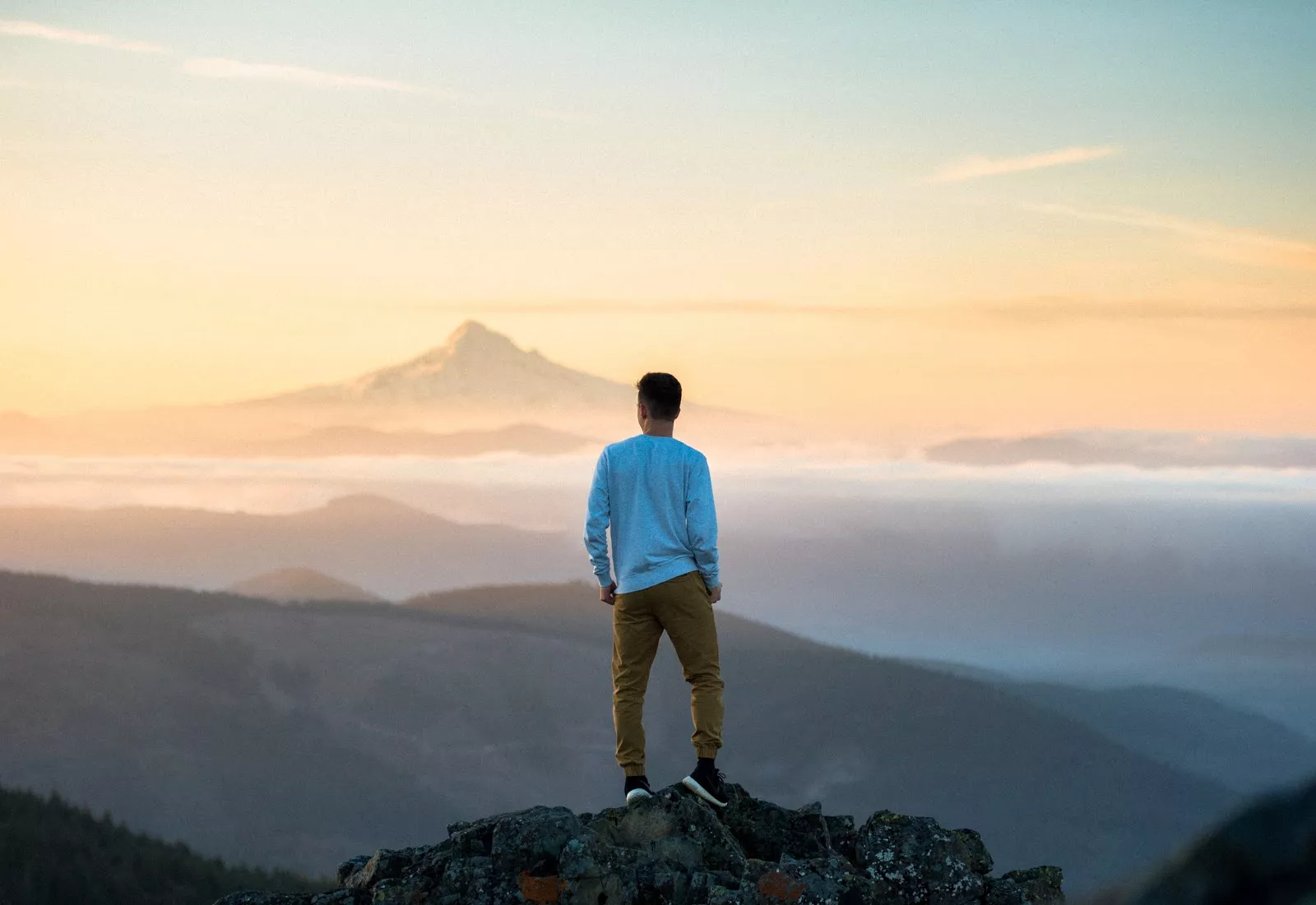 Man on mountaintop, content marketing success.