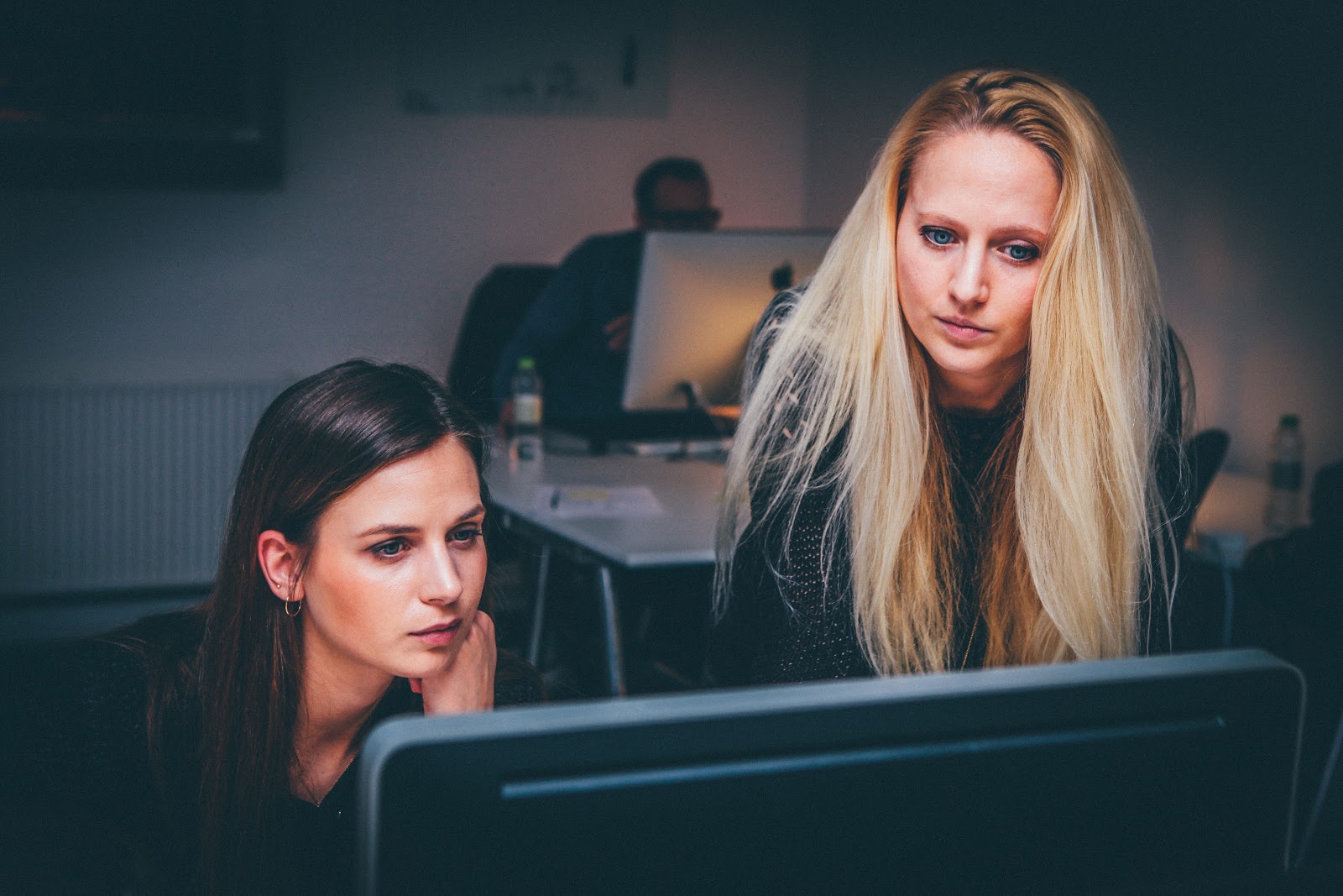 Women focusing on computer screen.