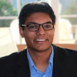 Man in glasses, smiling, business professional.