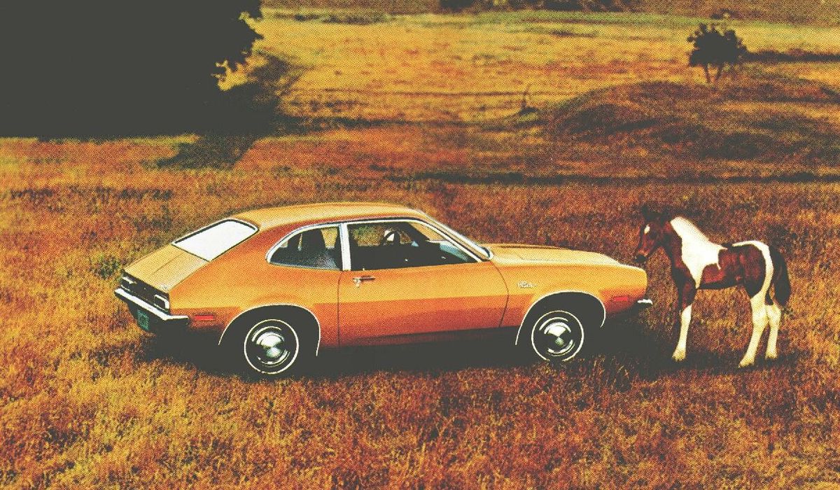 Orange car in a field.