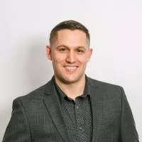 Man in suit, smiling, business professional.