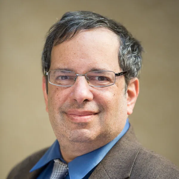 Man in glasses, discussing repetition.