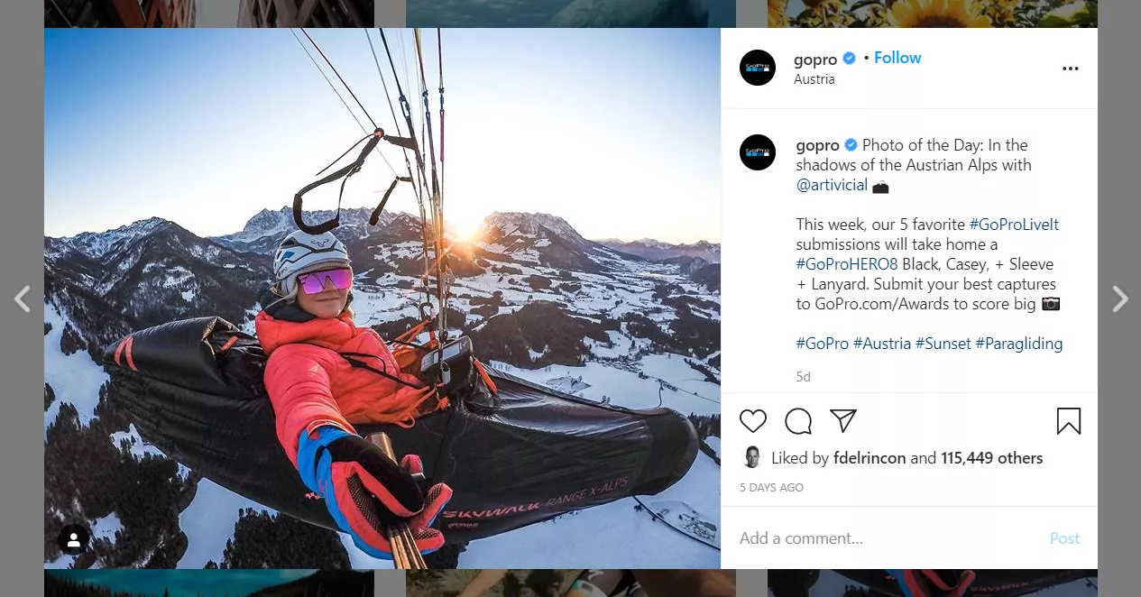 Person paragliding, snowy Alps.