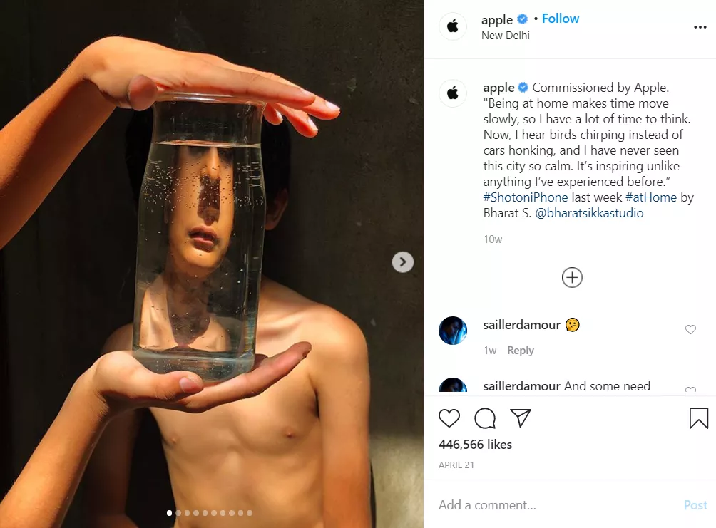 Person reflected in glass jar.