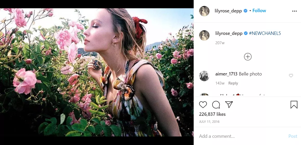 Woman smelling Chanel roses.