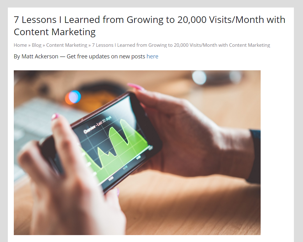 Hands holding phone, content marketing growth.