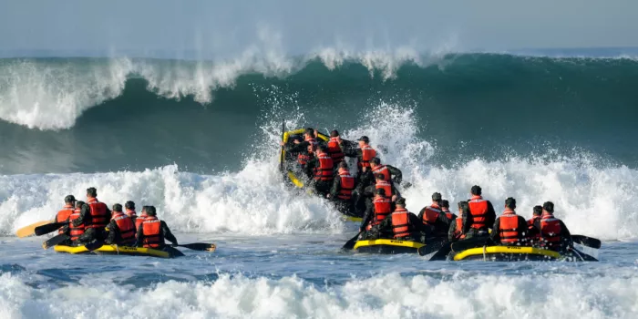 Navy SEALs in challenging water.