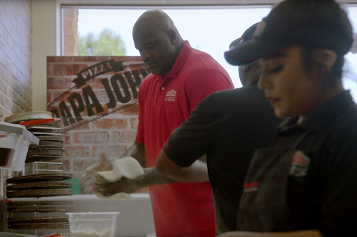 Papa John's employees preparing food.