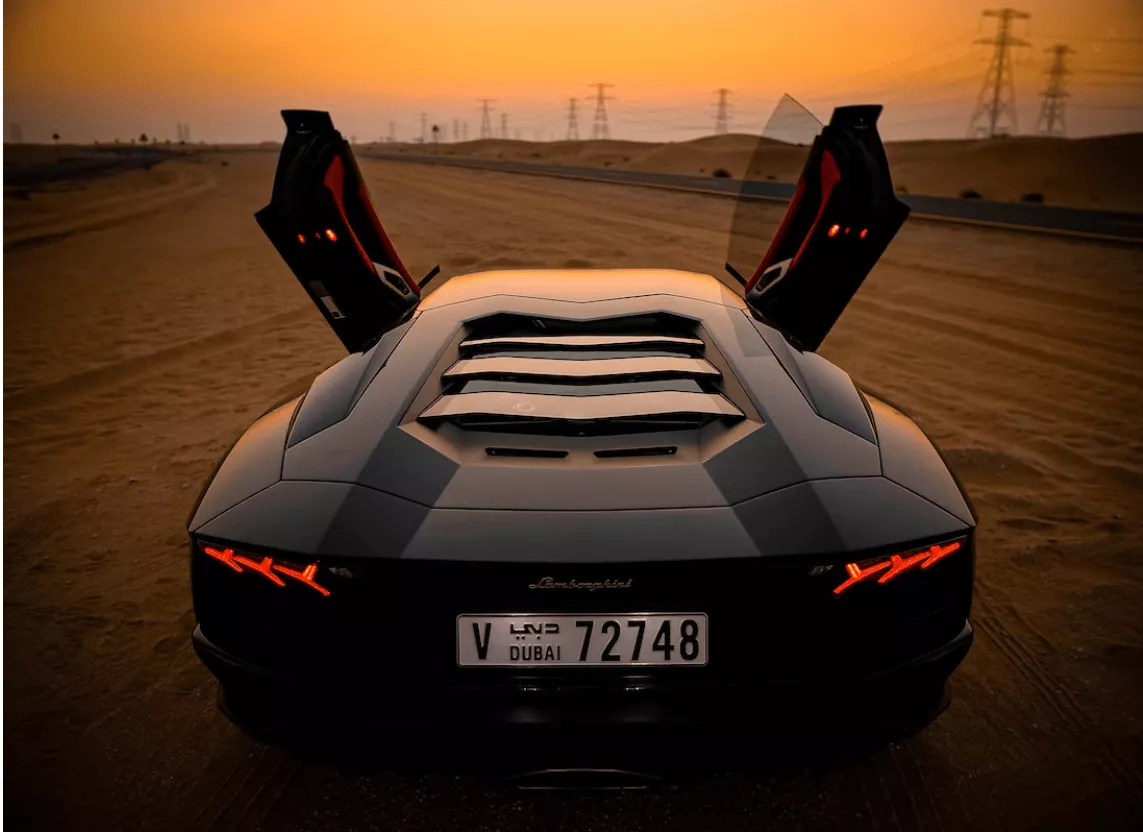 Luxury sports car, desert sunset.