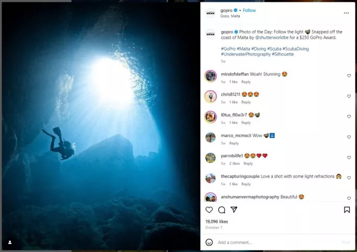 Underwater diver, sunlit cave.